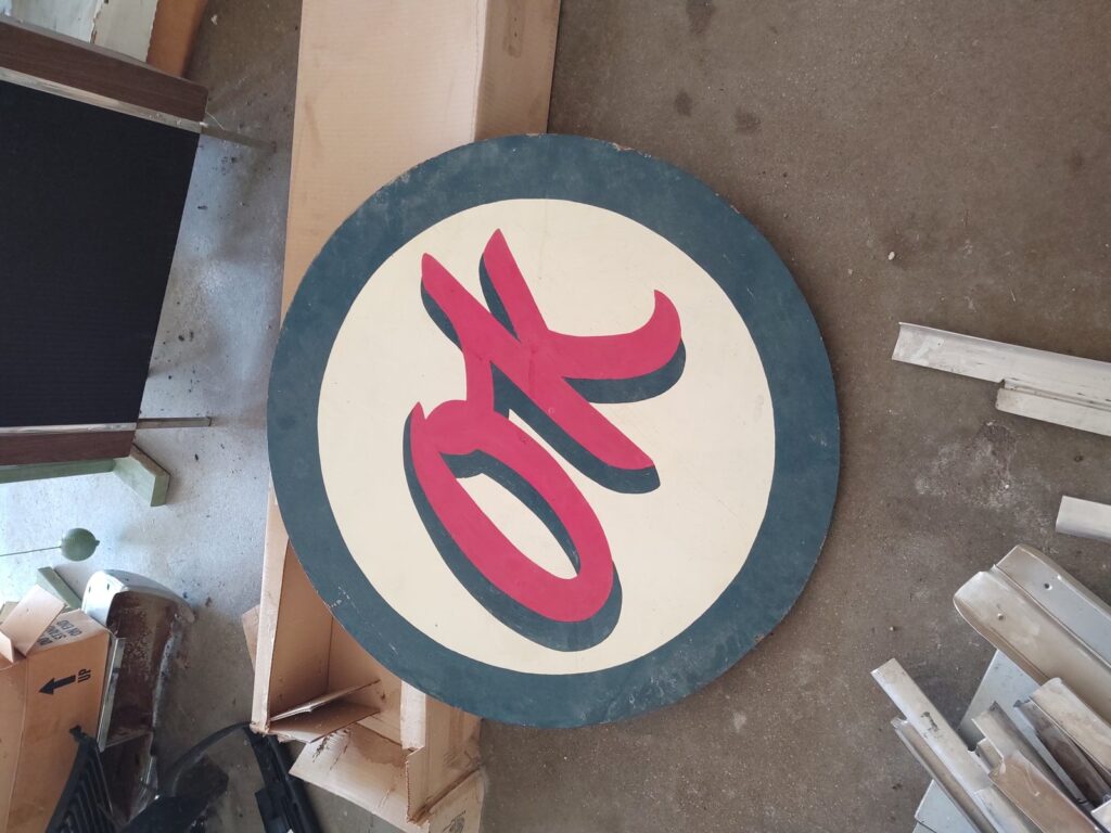 Vintage round hand-painted OK advertising sign